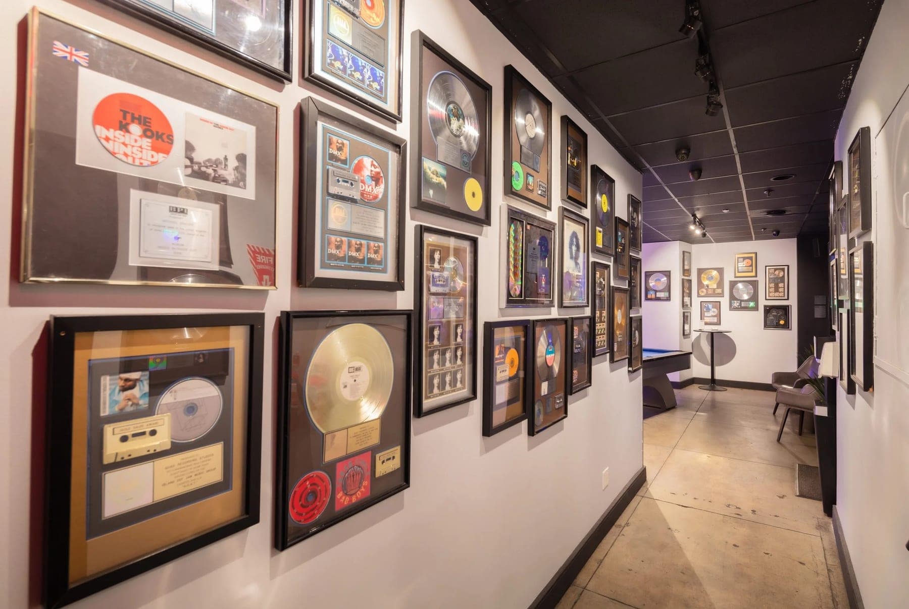 The hallway at Quad, lined with framed gold and platinum plaques